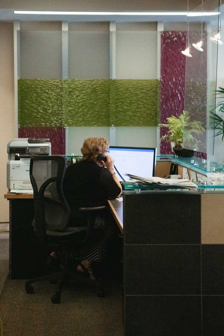 staff member on the phone in front of computer