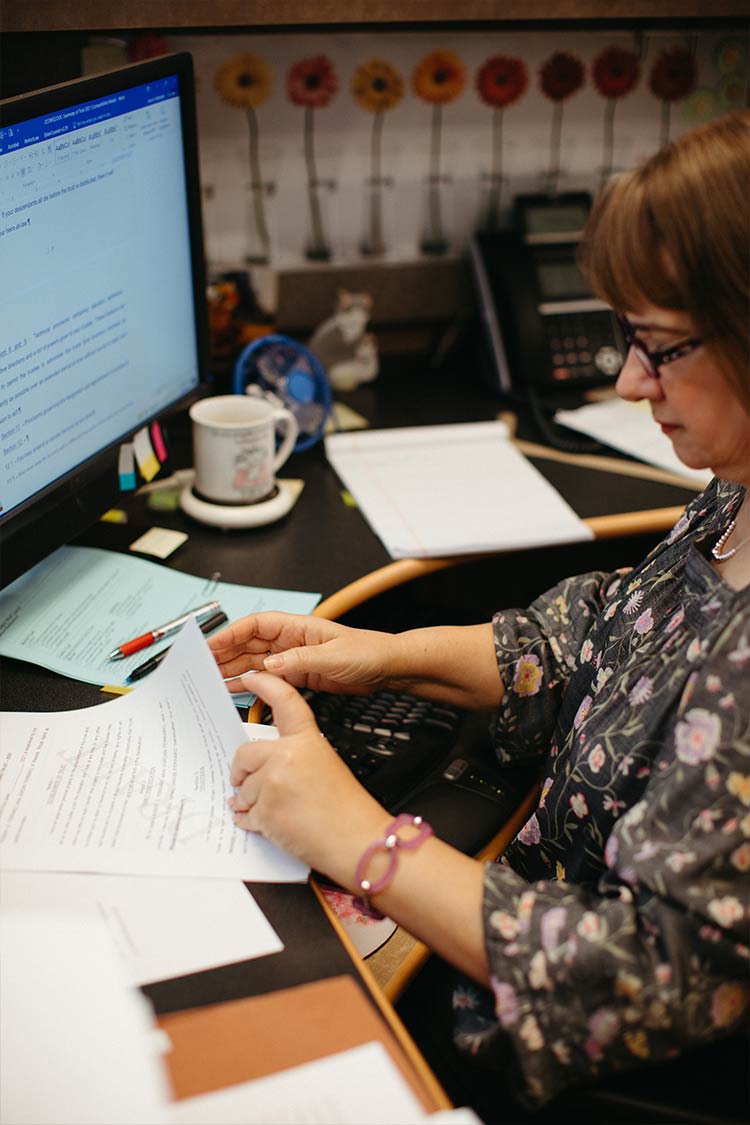 staff member at her desk working with documents